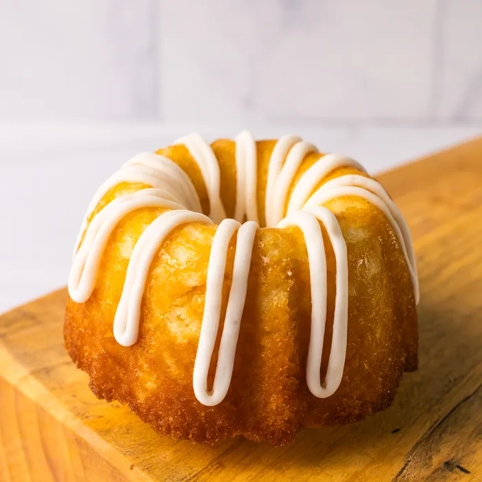 An almond mini bundt cake with white glaze.