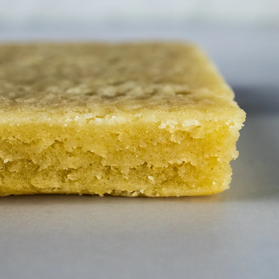 Shortbread cookies dipped and decorated, arranged on a light surface.